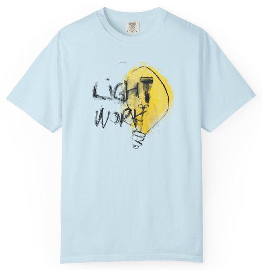 Light blue t-shirt with a yellow light bulb graphic and black text on a white background